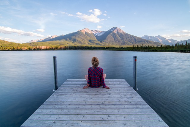 Person on a jetty looking at a scene